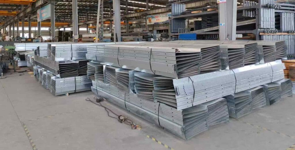 Stacks of heavy-duty galvanized wave platforms for automated parking lift systems in the Syrison factory.