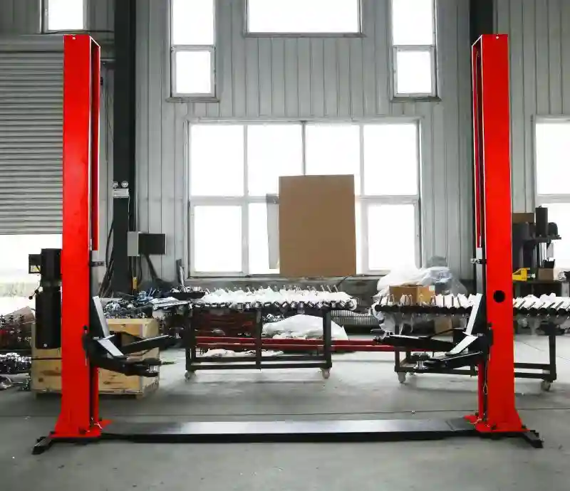 2 post car service lift with extended base frame installed in automotive workshop