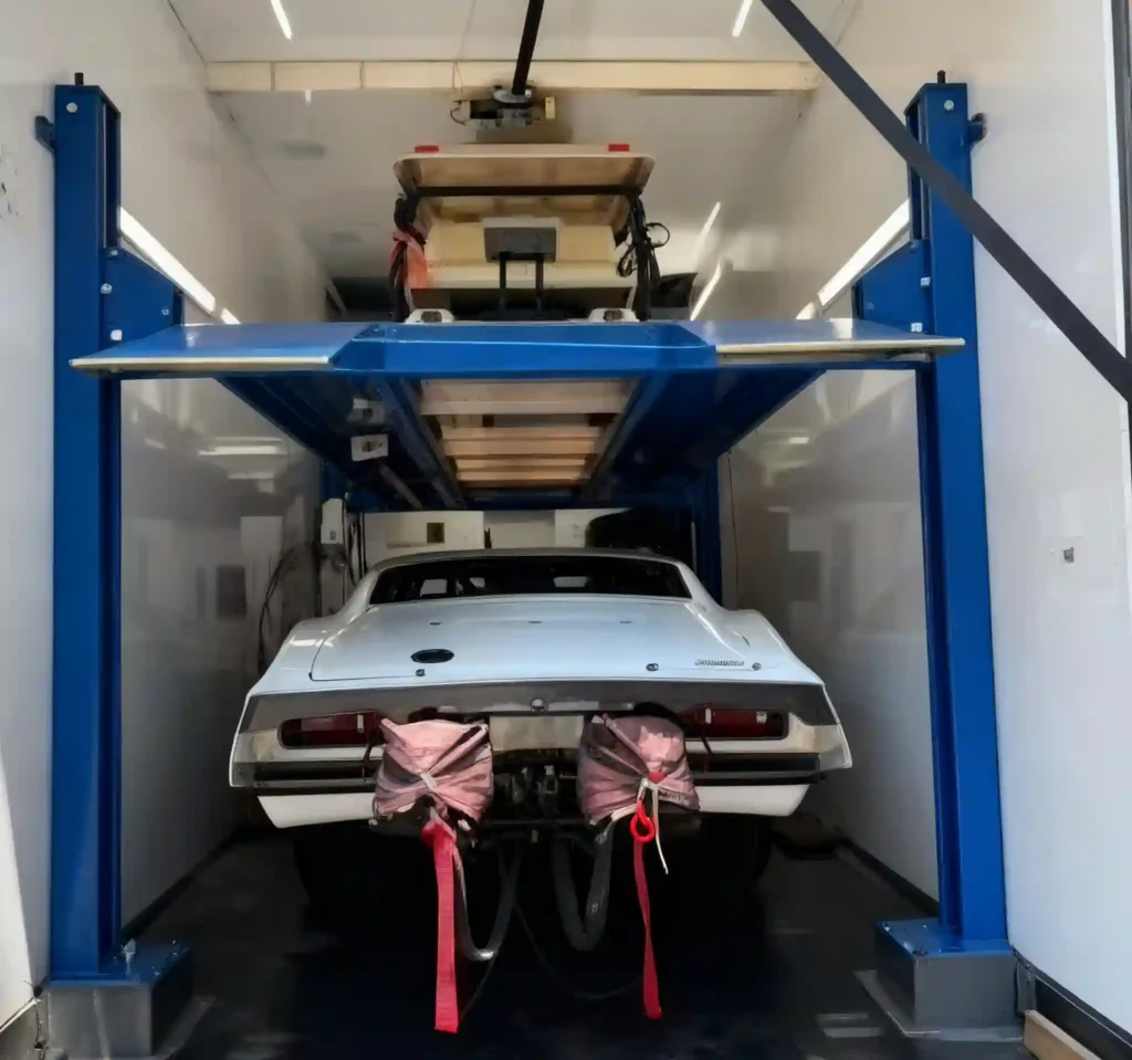 Custom slim four post car hoist installed inside an enclosed truck for an Australian customer